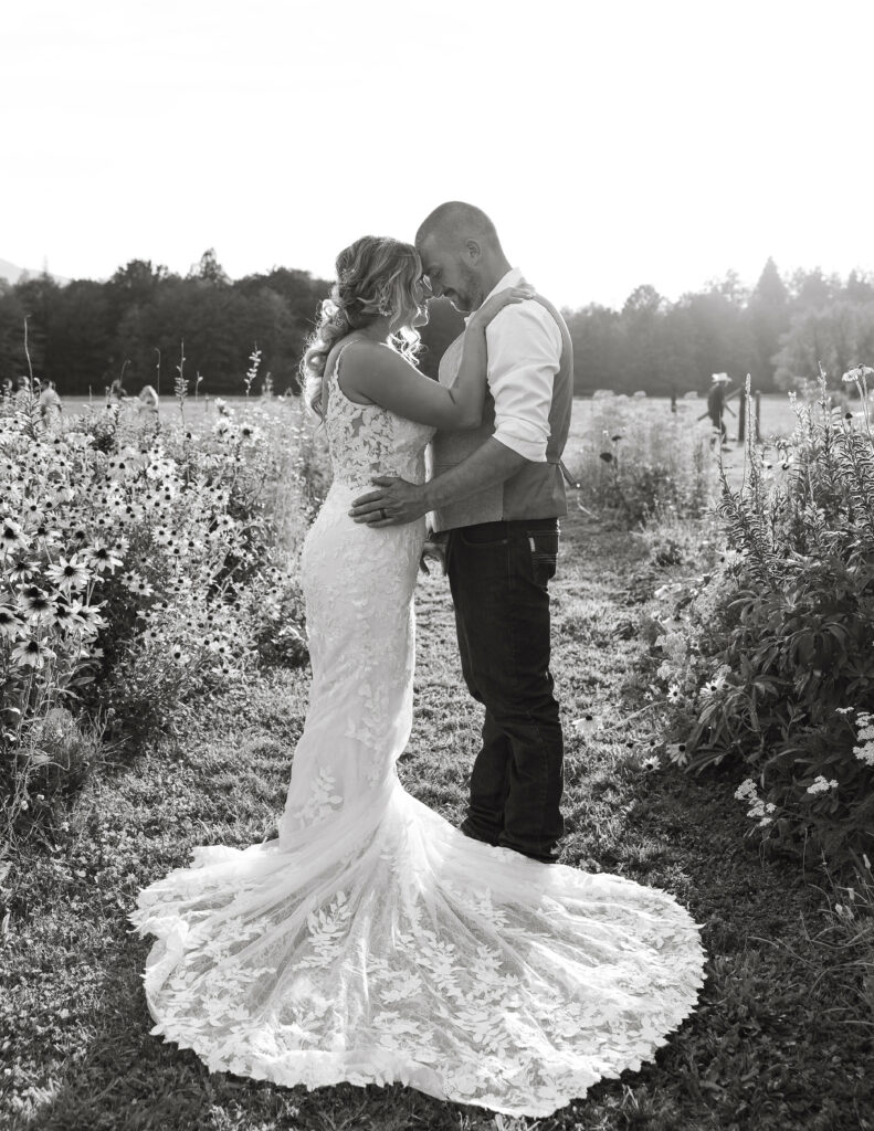 Bride and groom in a field of wild flowers